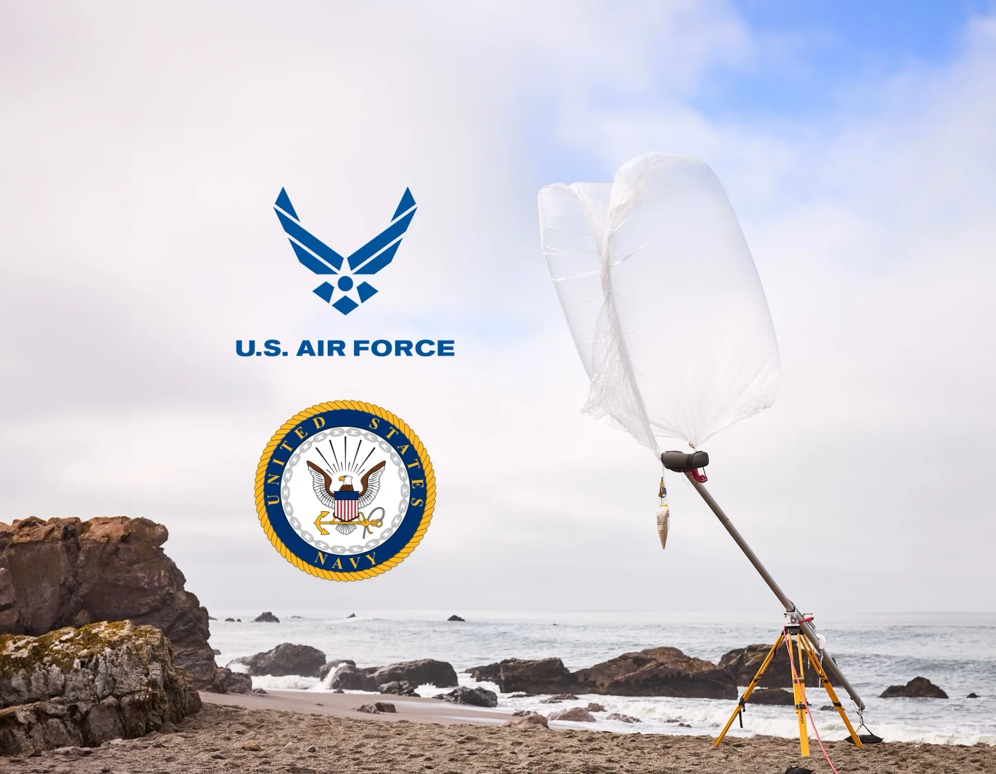 WindBorne balloon on a coastal launch rig beside U.S. Air Force and Navy award logos.