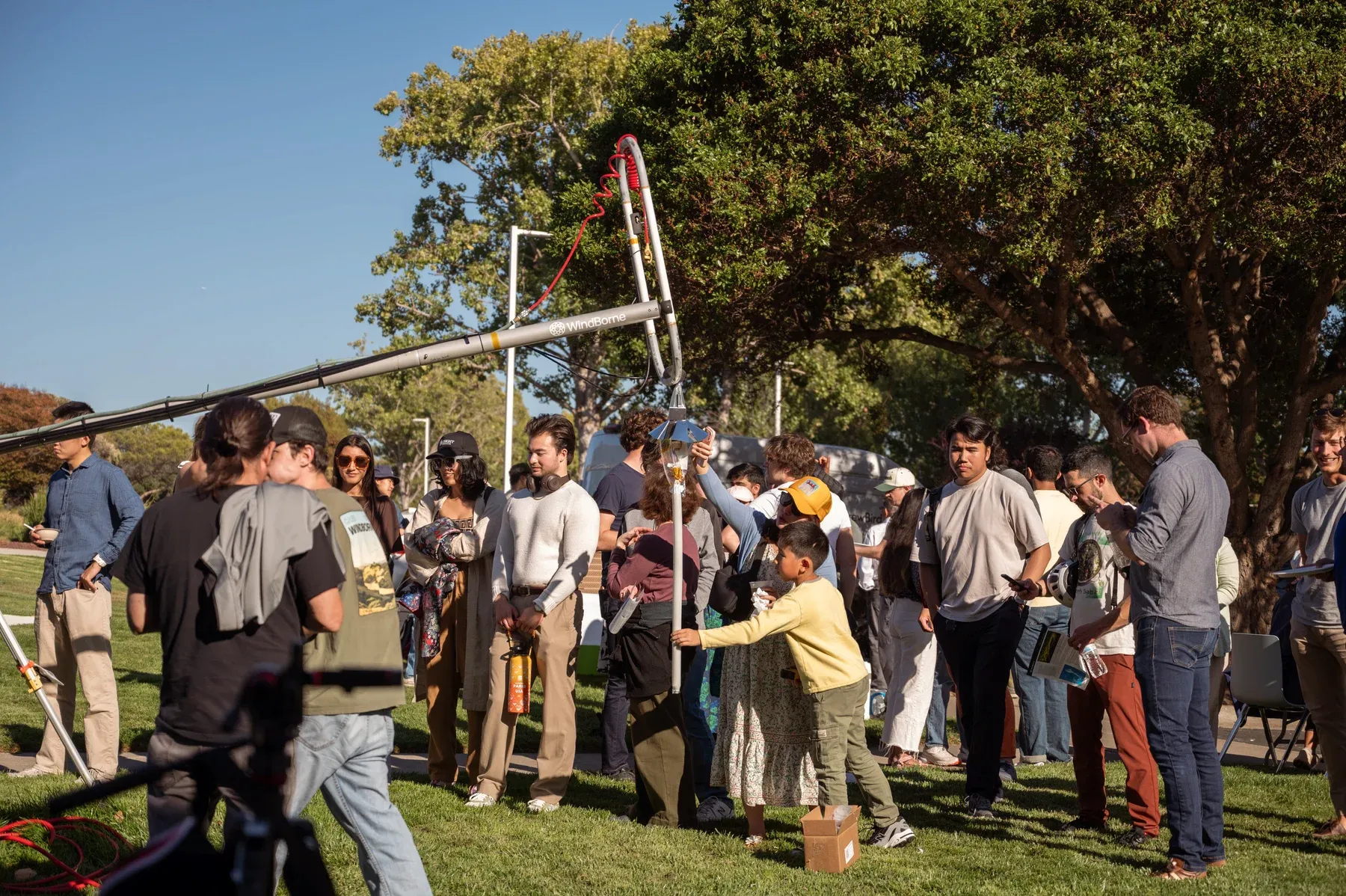 Visitors gathered around a balloon and launch equipment outside WindBorne headquarters